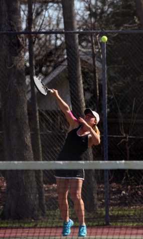 Eve Small serves during her singles match against Prairie
