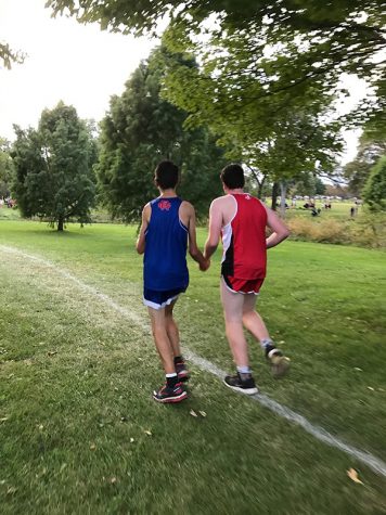 Evan Hanson '19 assists a Washington runner during a race at Noelridge Park.