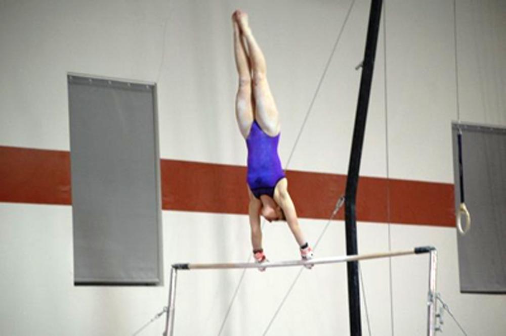Emma Gier 13 demonstrates her skills with her bar routine. Photo by Beth Gier