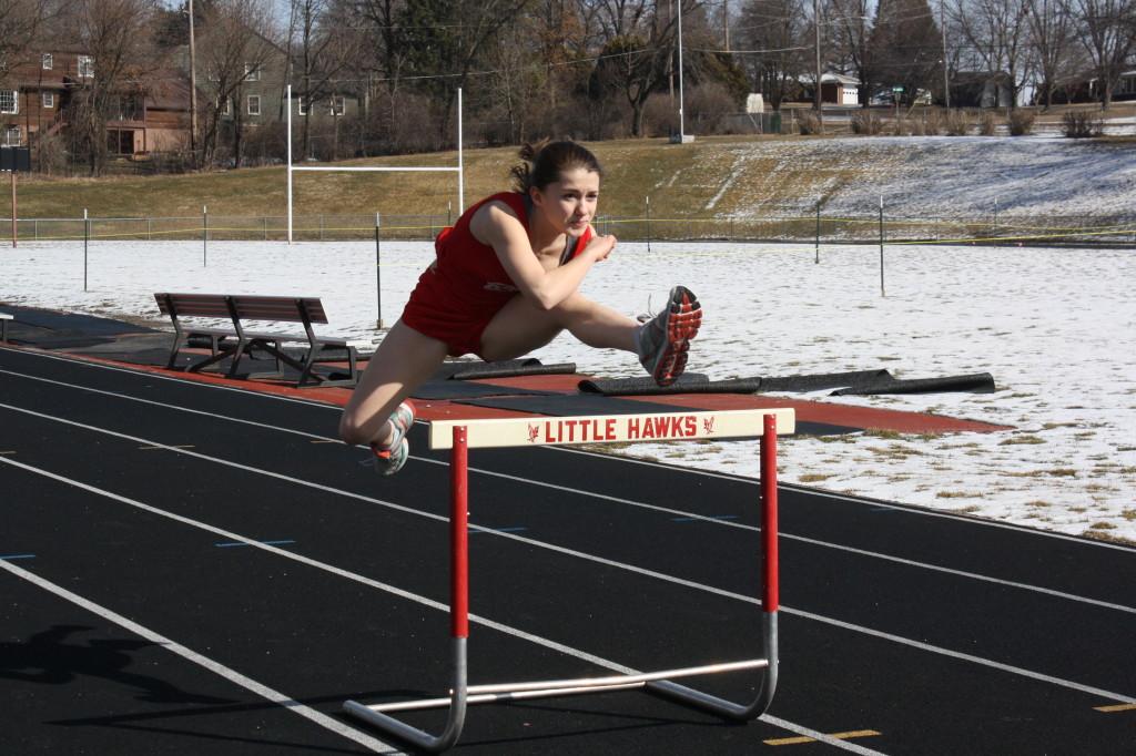 Terra Perez takes a hurdle in stride on the track. Photo by Daniela Perret