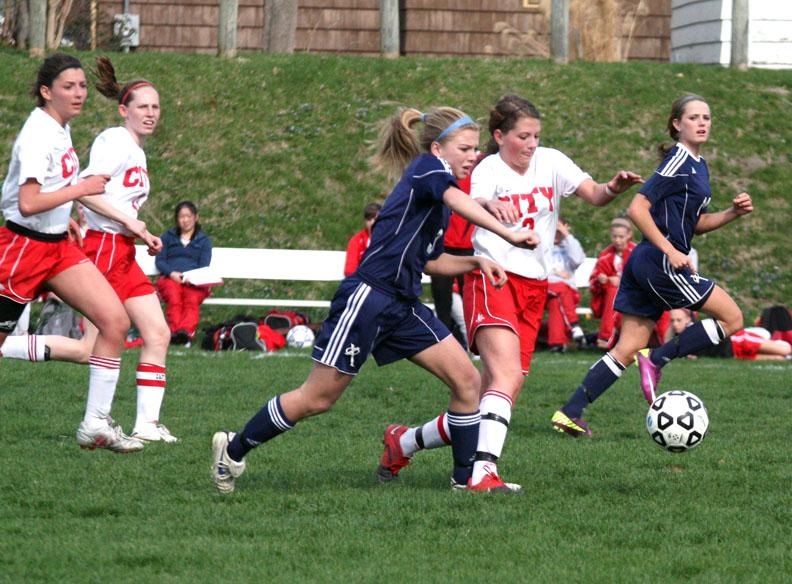 Abby Schroder 12 battles for the ball against Xavier in the 2011 season.  Photo by Renata Stewart