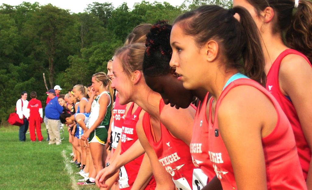 XC girls line up for the start of a race Photo by The Little Hawk
