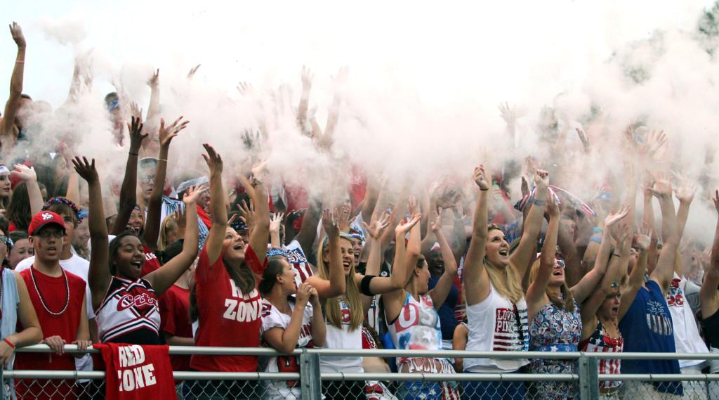 The Red Zone celebrates with baby powder during the football teams home opener.  Photo by Kira Zapf