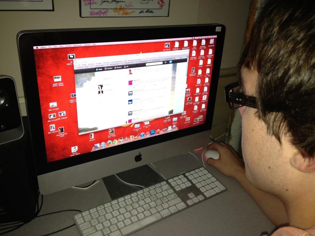 Kieran Green checks his Twitter account.  Photo by Caroline Brown