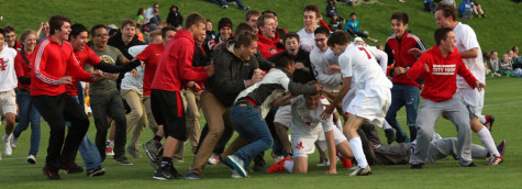 Scott Tribbey falls to the ground amidst the rush of City High fans. 
