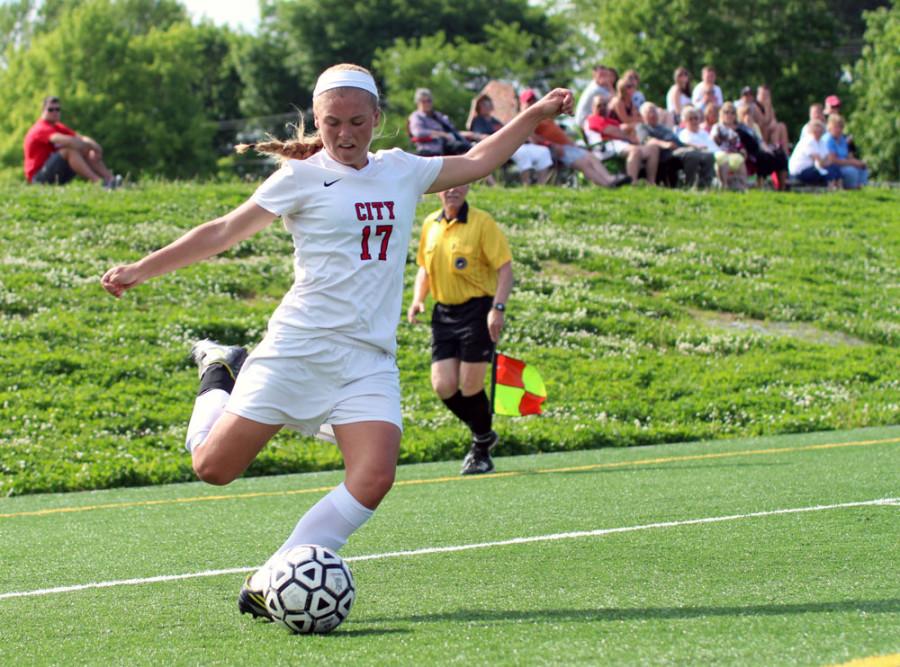 Grace Brown 17 kicks the ball towards goal with all her might