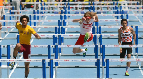 K. Butler jumps over a hurdle in the 110 meter hurdles. K. Butler finished in  14.98, 11 places  ahead of West's Elliot Young.