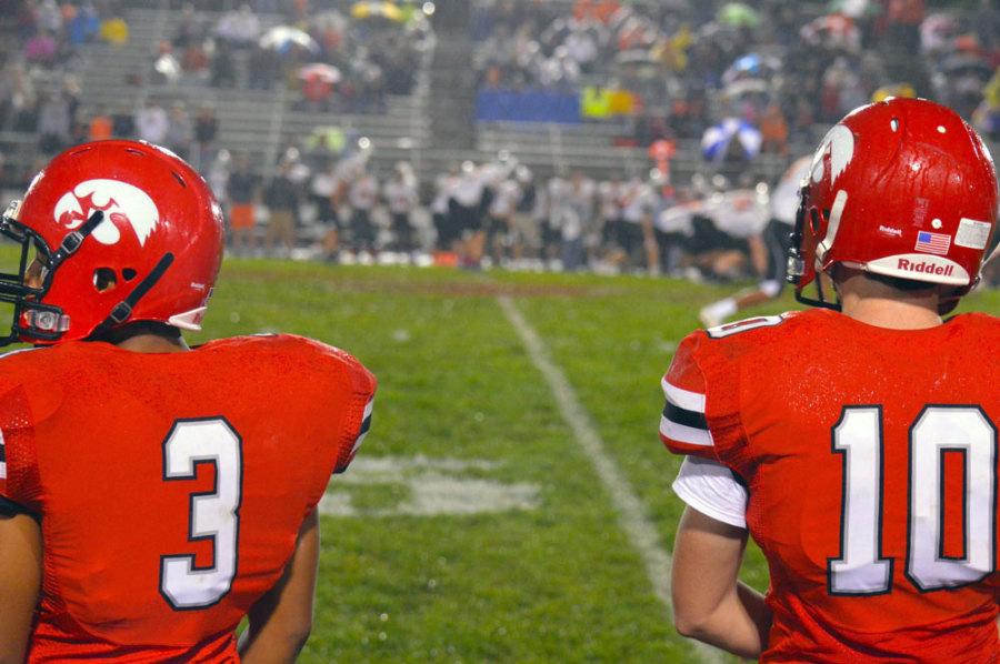 #3 Djimon Washington 16 and #10 Kyle Swenning watch a play from the sidelines against CR Prairie.