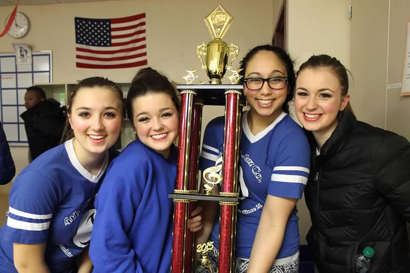 Fourth Avenue singers including Libby Fischer (15) hold their second place trophy.