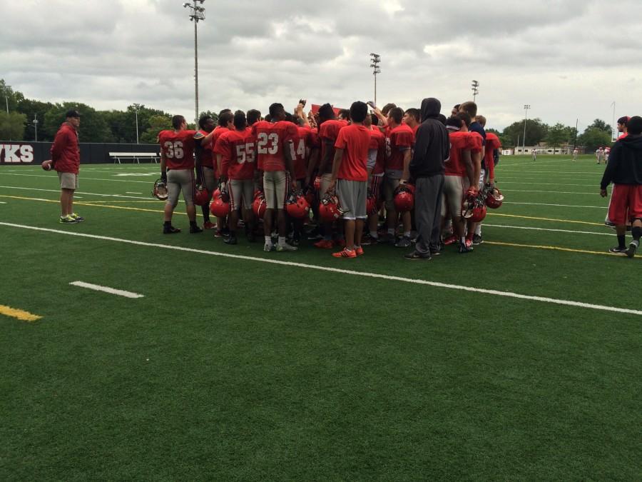 Little Hawks huddle at practice Thursday the 27th.