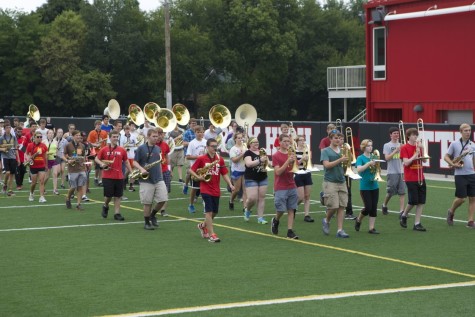 Marching band students practice on the soccer turf. 