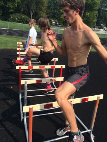 Aaron Romano '17 does hurdle drills at cross country practice.