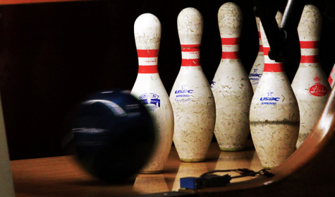 A ball rolls towards the pins during bowling practice at Colonial Lanes
