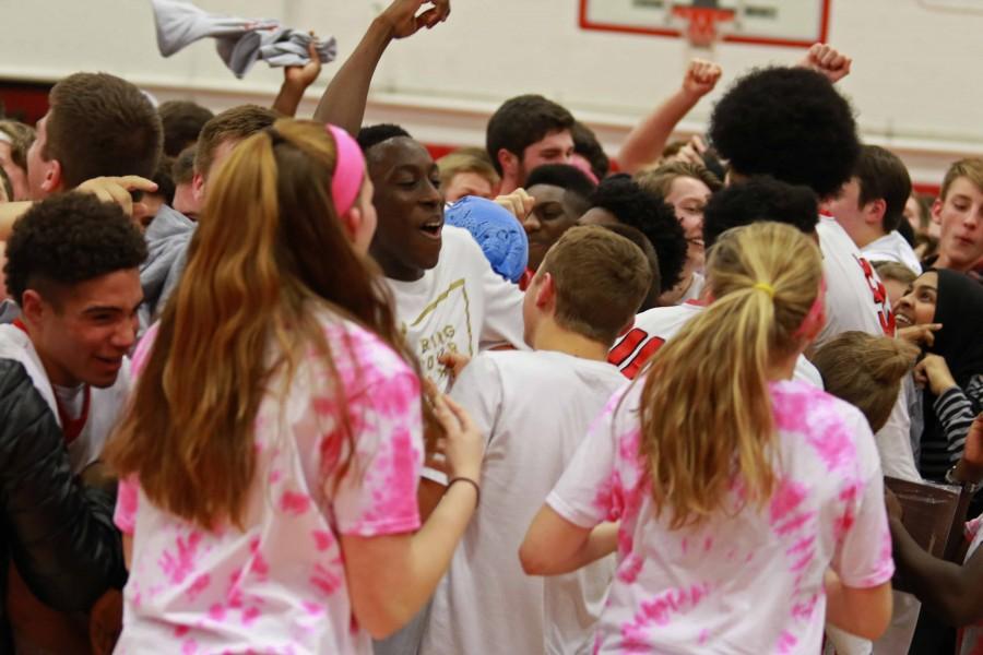 Fans celebrate on the court with the Little Hawks' players following their (63-52) victory over West High's Trojans at City High on Friday, February 12th, 2016.