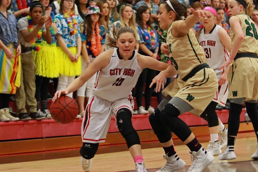 Ashley Joens 18 drives towards the hoop darting around West High defenders.