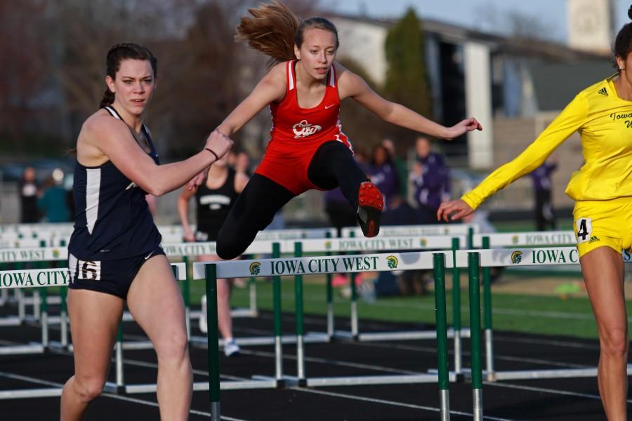 Kate Swenning 19 clears a hurdle in the 100 meter varsity event on Tuesday, March 29th, 2016.