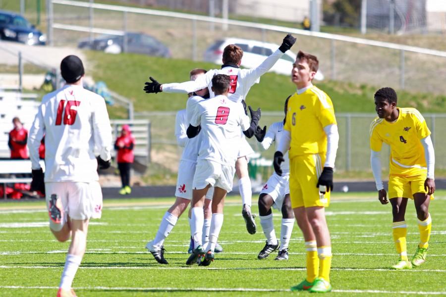 Teammates celebrate with Mitchell McCarthy 16 after his goal during the Varsity Classic.