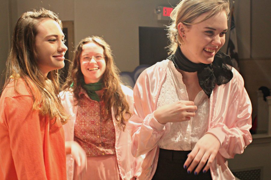 Marissa Rude 19,  Serena Collins 18, and Genevieve Wisdom 17 share a laugh on stage before a run through of the show.