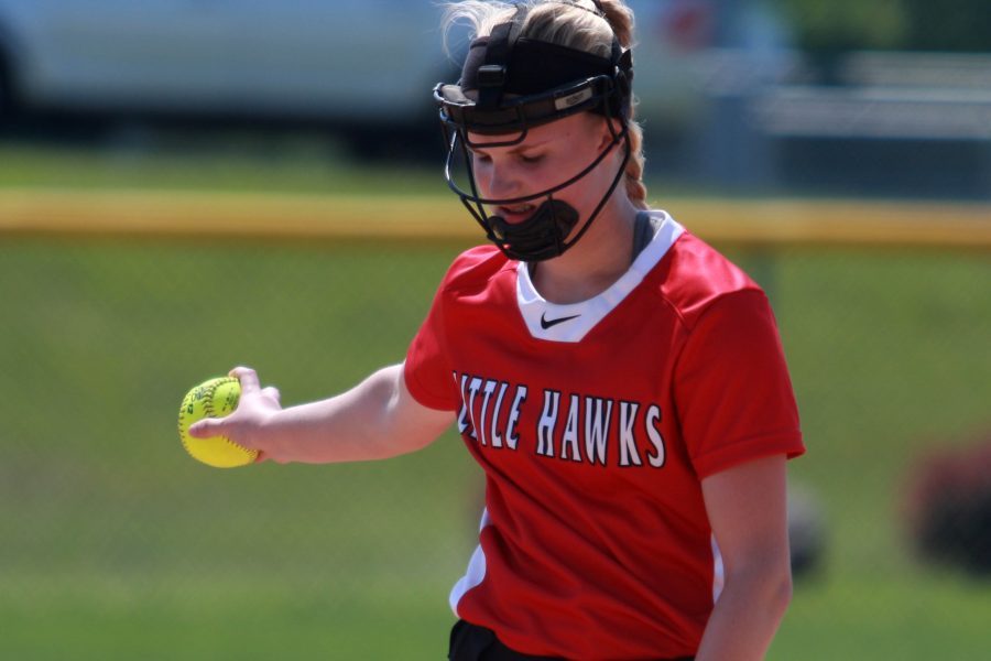 Gabi Hiatt '17 tosses the ball to herself on the pitcher's mound at West High school during the Little Hawks' makeup rainout game against the Women of Troy on Friday, June 10, 2016.