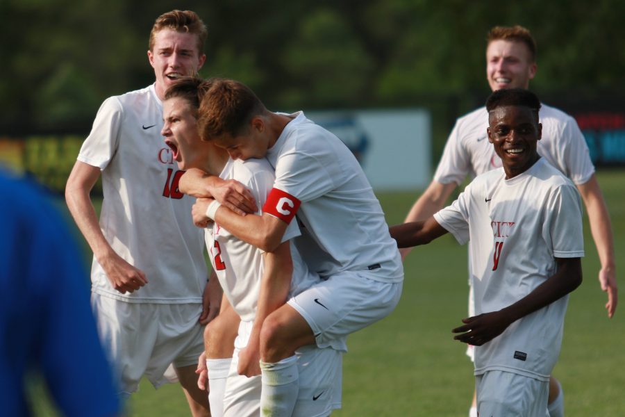 Mitch McCarthy '16 (C) leaps onto the back of Jackson Meyer '18 (12) in celebration after Meyer's goal against the Little Cyclones during City High's semifinal game in Des Moines at the Cownie Soccer Park on Friday, June 3, 2016.