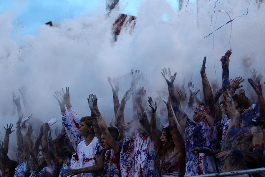 The Class of 2017 throws baby powder in the air to celebrate kickoff against Linn-Mar on Friday, August 26.