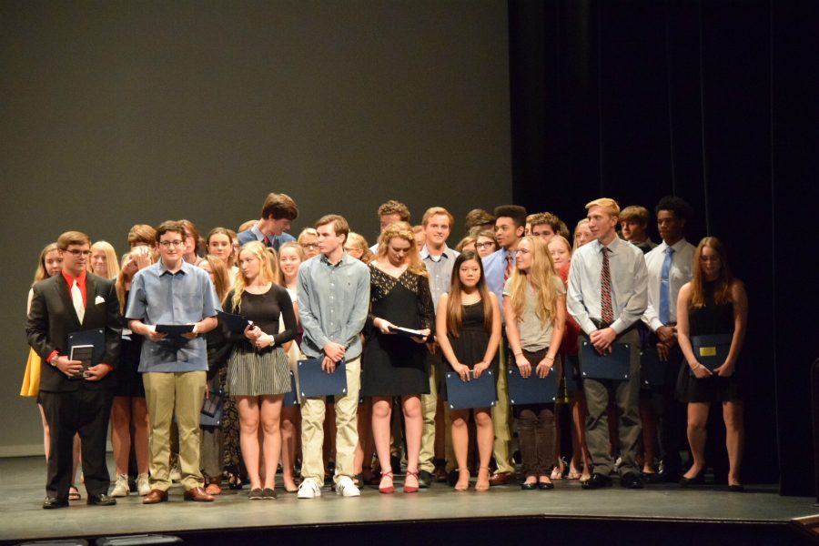 Students from City High stand on the Englert Theatre stage as they receive their certificates for the Youth Salute award, sponsored by Hills Bank. 