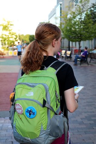 Riley Lewers clipboards in the pedmall on September 19th.  Her pins signify the political organizations she has worked for in the past.