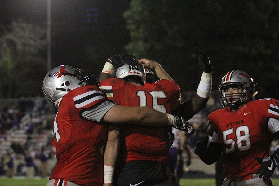 The team hugs and pats QB Nate Wieland after making a play.