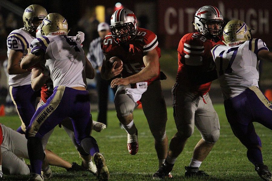 Quarterback Nate Wieland 17 rushes in for a touchdown against Muscatine.