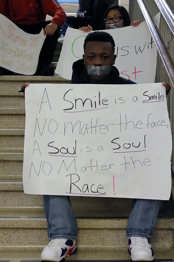 Anthony Foster 17 sits in solidarity with those who have experienced discrimination in the wake of the election.  Foster, along with the other nine protesters, gathered during lunch to make signs for the protest held later that day.