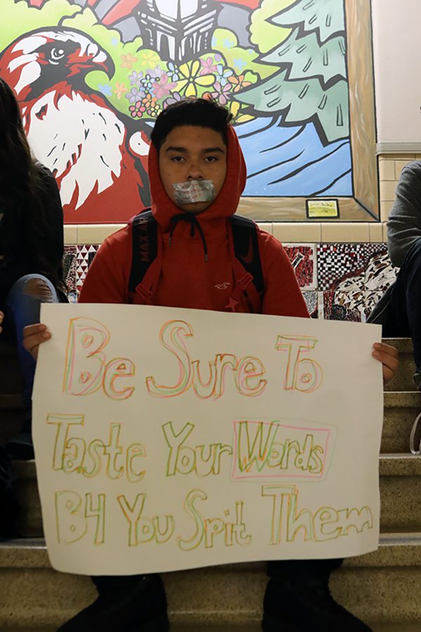 Byron Ortiz 18 silently protests on Friday, November 18th.  The tape over Ortizs mouths reads wall jumper.  The aim of the protest, Ortiz said, was to stand in solidarity with those subjected to discrimination.