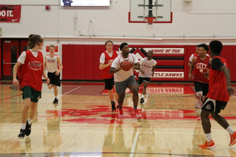 Chuck Johnson 17 looks down court to pass during the Red & White Scrimmage