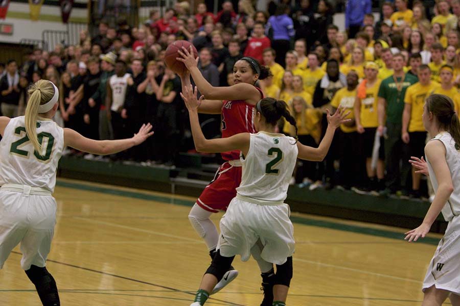 Rose Nkumu 20 searches for a teammate to pass to against West High on December 13th at West. 