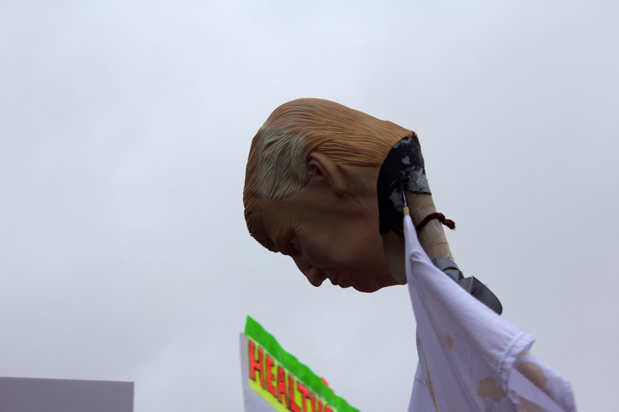 A plastic form of President Donald Trumps face hangs off a pole.