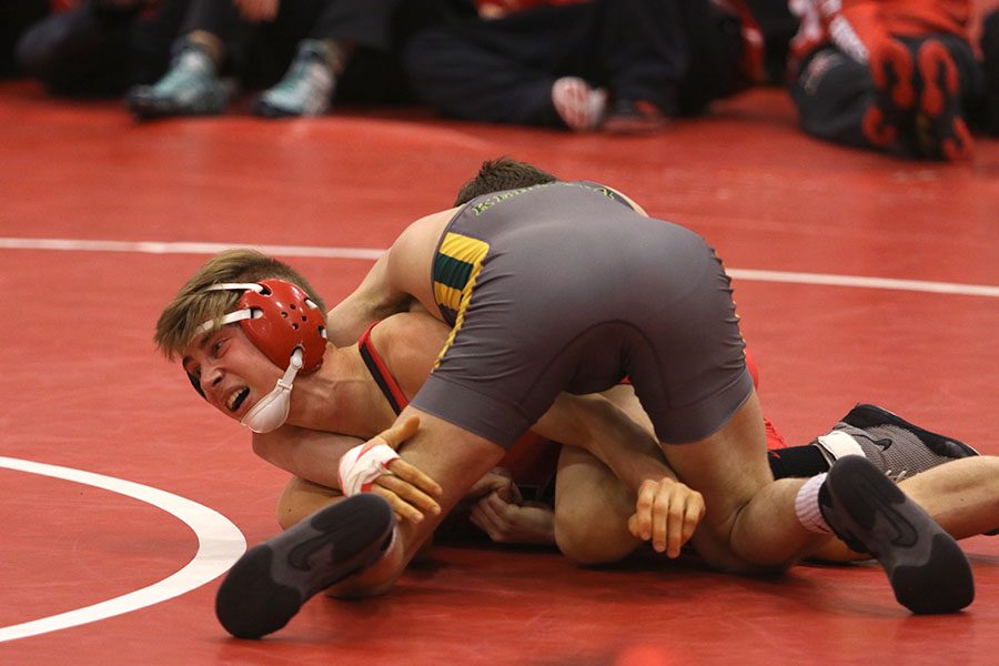 Bryan berg 17 attempts to escape a hold against a Kennedy opponent.
