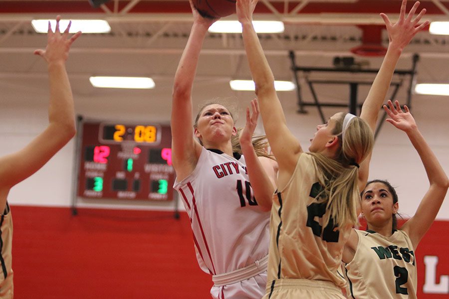 Ashley Joens 18 shoots over a West High defender in the first quarter.