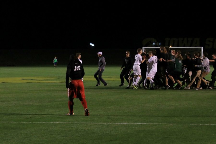 City Highs Imata Mwenekamba 17 walks off the field as West High fans storm the field in celebration. 