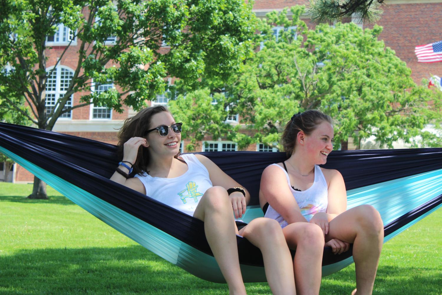 Clara Froeschner 18 and Devan ORourke 17 sit in a hammock on the front lawn of City High School.