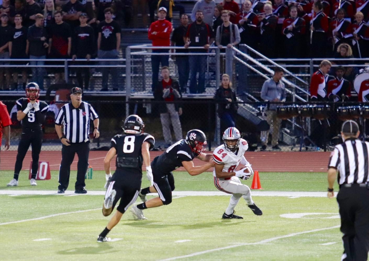 Zach Jones 18 evades oncoming defenders during the Little Hawks season opener at Linn-Mar. 