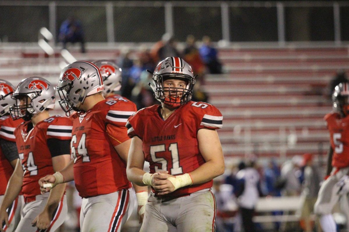 Liam McComas 19 looks to his coaches between plays, Friday night against Davenport Central. The Little Hawks lost 63-28.