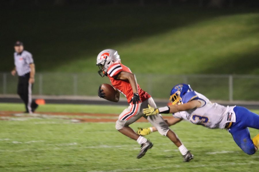 Marquel Poole 18 escapes an oncoming defender during the Little Hawks season closer against Davenport North. 