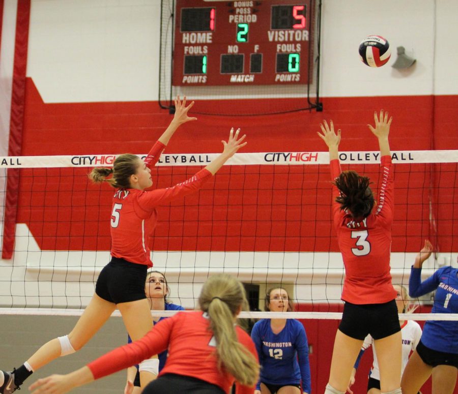 Lindsey Bolton 20 and Mackenzie Murphy 19 team up for a block against Cedar Rapids Washington.