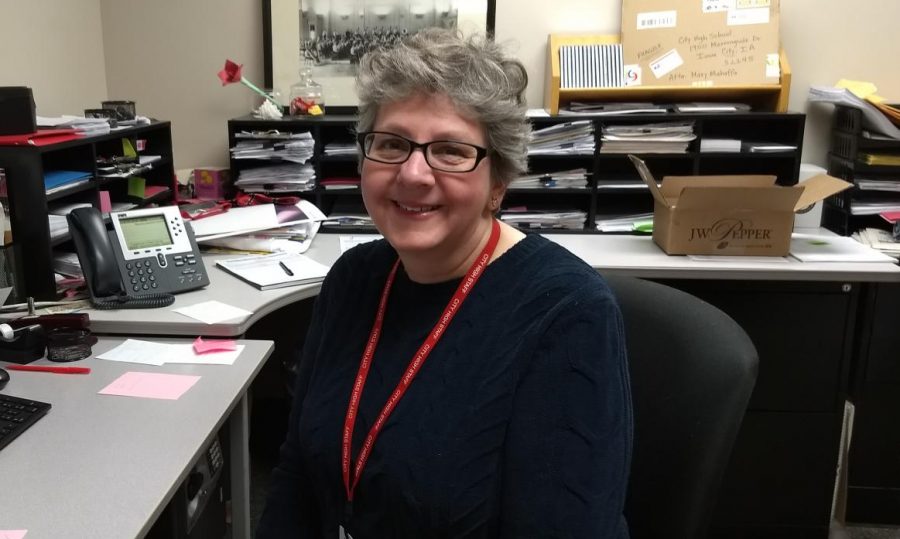 Mrs. Mahaffa sits in the office where she performs her duties as music secretary.