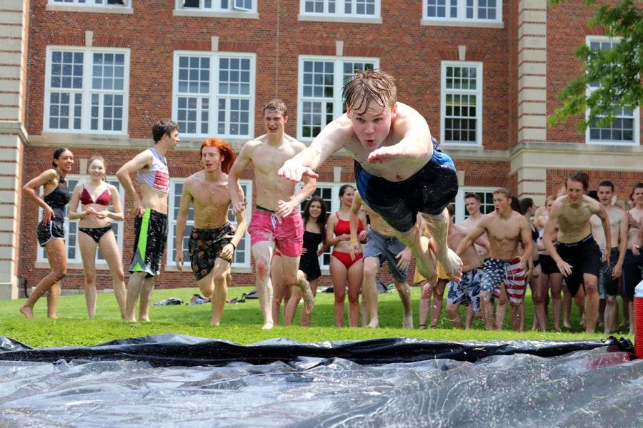 Maclane Henry 18 jumps down the slip and slide on the first ever slip and slide event on his last day of high school.  Photo by Zoe Butler