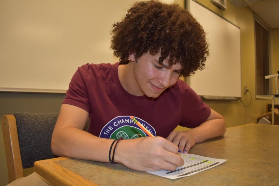 TJ Murphy 19 fills out a voter registration form.
Photo by Olivia Lusala