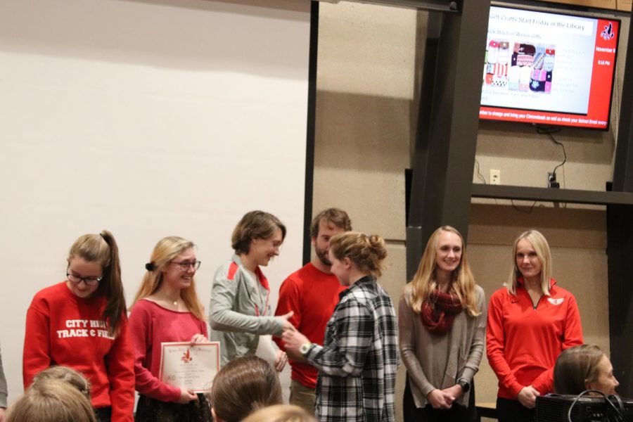 Julia Veit 20 is congratulated along with fellow juniors Mary Bounds and Estella Brady.