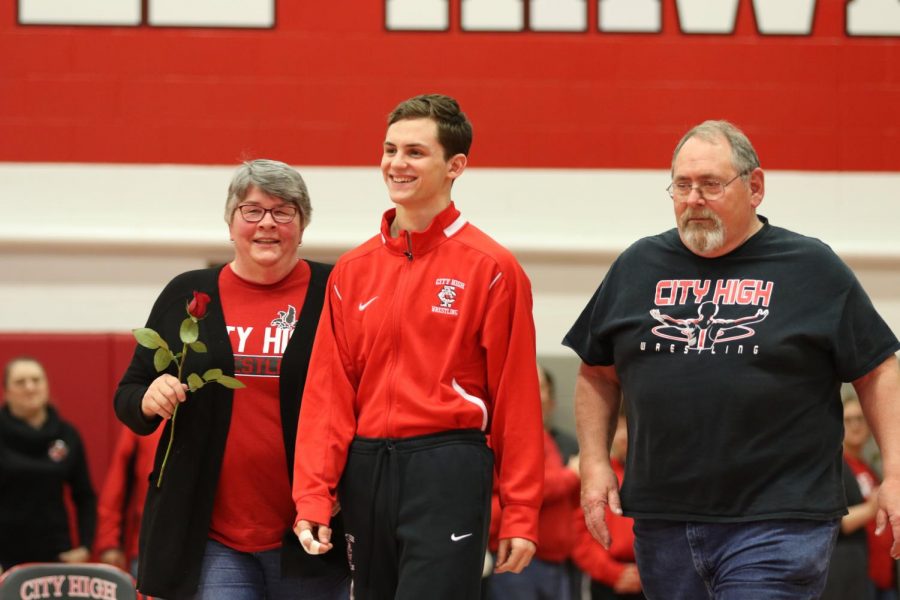 Senior Brandon Lalla escorted by his parents