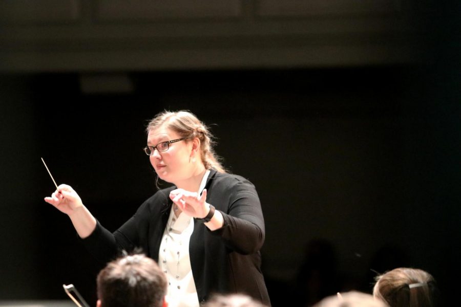 Mrs. Stucky Conducts both members of the Wind Ensemble and the Orchestra during the last song.