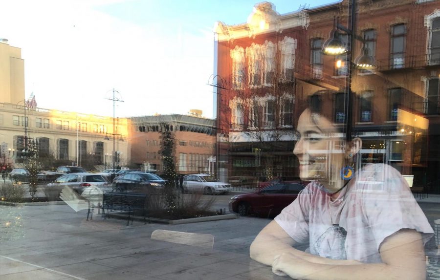Esme Rummelhart 17 enjoys the view of downtown Iowa City from inside the Java House in downtown Iowa City. 