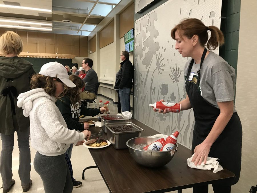 Booster Club volunteer serves thousands of pancakes to hungry customers 